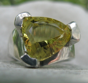 Unusual citrine - nothing symmetrical about the facets done by and expert stone cutter.  The 3 pronged setting emulates the 'trillion' shape of the stone.